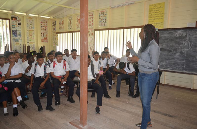 Ministry of Public Health, Adolescent Health Coordinator, Dr. Oneka Scott interacts with pupils