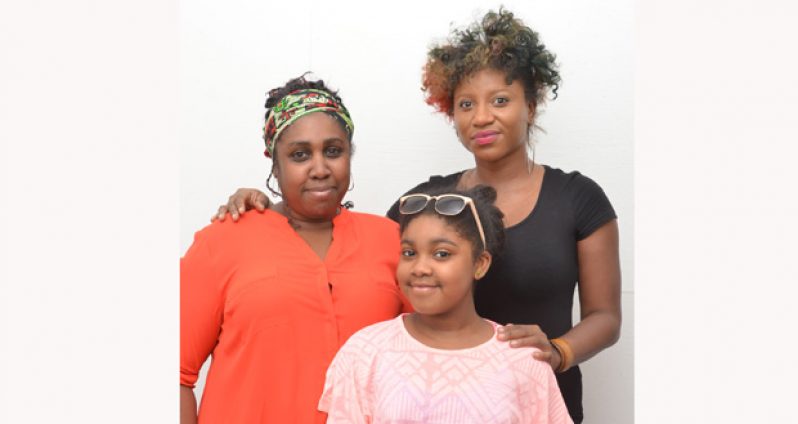From left:  Chairperson of “Women of Kaieteur”, Ms Roianne Nedd, and Board Member Amanda Wilson.  At centre is Roianne’s daughter, Christianna Nedd