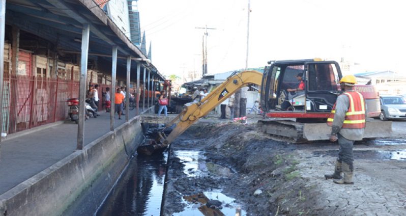 Desilting the Orange Walk drain east of Bourda Market