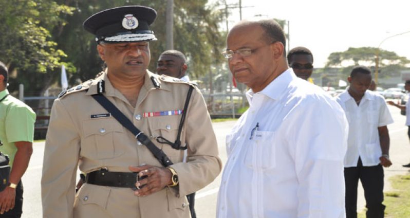 Commissioner of Police Seelall Persaud and Home Affairs Minister Clement Rohee interact before the official opening of the conference yesterday (Photo by Delano Williams)