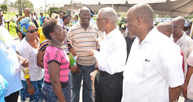 President David Granger interacts with a resident at the  first Meet the Public Day hosted in December last year at the Square of the Revolution, Georgetown