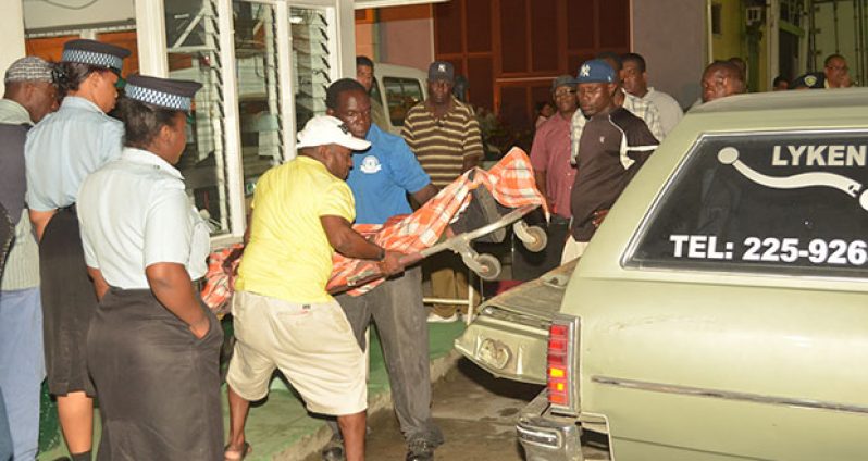 Undertakers removing the body of the man from the security hut