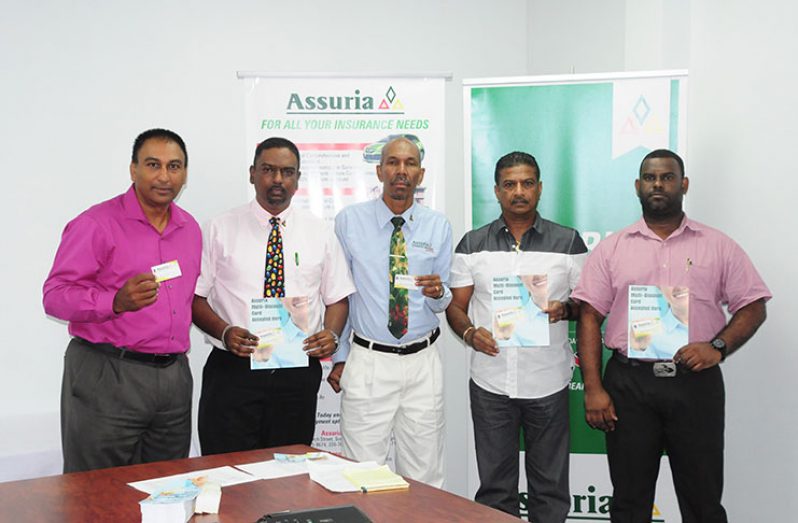 At Thursday’s launch of the multi-discount card are, from left: NexGen’s Vice-President, Aleem Hussain; Assuria’s General Manager, Yogindra Arjune; Erwin Daniels also of Assuria; Steve Narine of Steve’s Jewellery; and National Hardware’s Damion Singh  (Photo by Delano Williams)