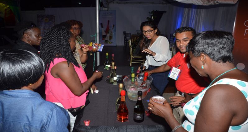 Persons delighted with the cocktails at Ansa McAL’s booth