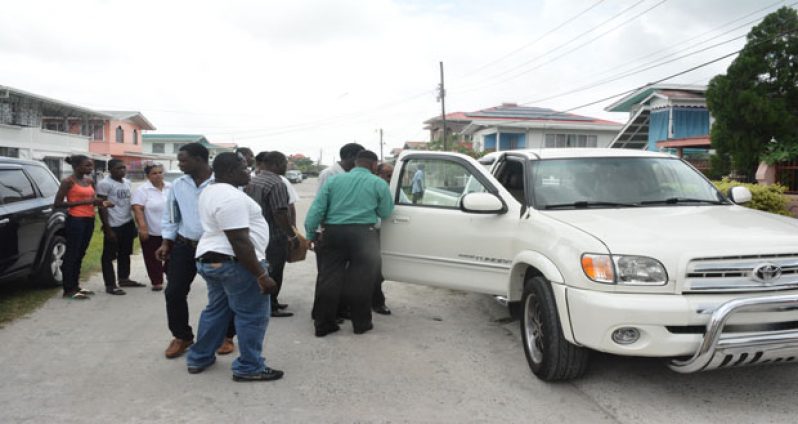 One of Hamid’s vehicles being examined by police investigators and relatives on Thursday