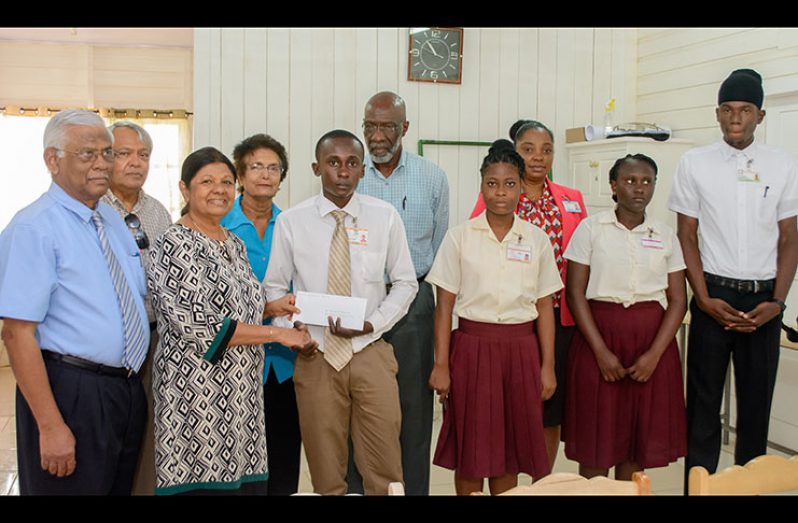 Gafoor Foundation Board member Ameena Gafoor presents an award to student Rondell Dazzell at the presentation on Wednesday. Others from left are Executive Chairman of Gafson’s Industries, Sattaur Gafoor; Mohamed Ali (Board member); Sylvia Conway (board member, Gafoor Foundation); Vincent Alexander, Chairman of the Board of Governors, (GTI); Alexandria Clarke (student); Principal (Renita Crandon) and Natasha Hunter and Leon Lewis (students)