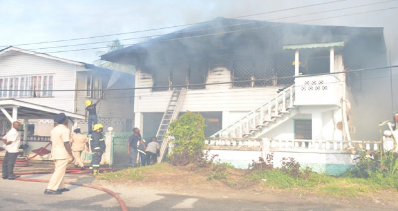 Firemen dousing the flames at the East Street house yesterday afternoon