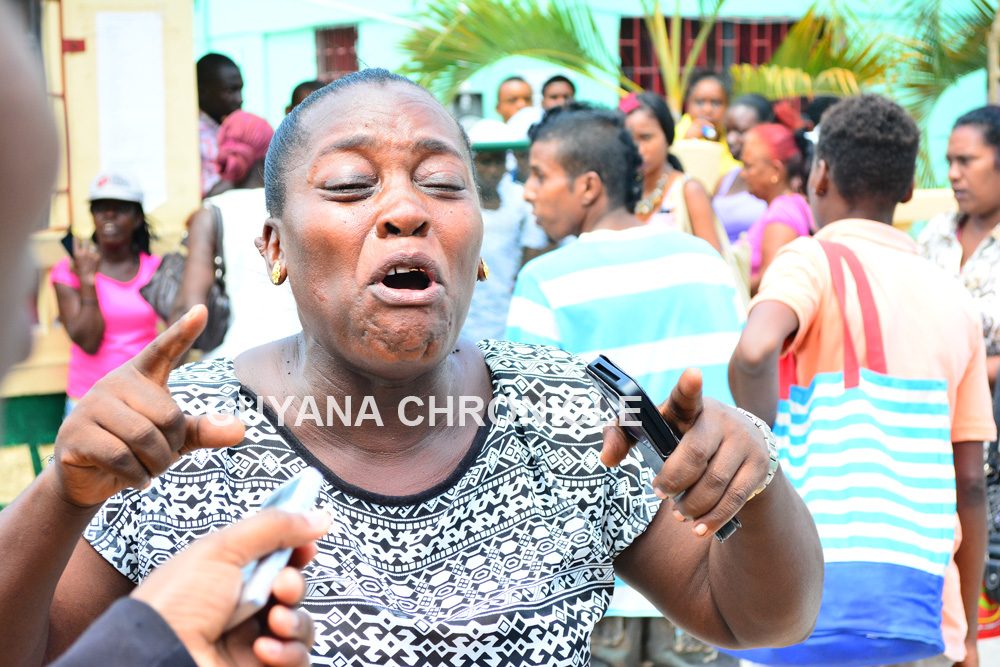 A woman reacts to news of what happened to her relative  at the Camp Street Prison