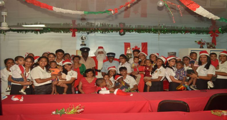 Director, Ms. Maylene Singh (front row, third right) with her students and kids of the Red Cross Convalescent Home at the party last Wednesday.  With them also are two ranks from the nearby Kitty Police Station