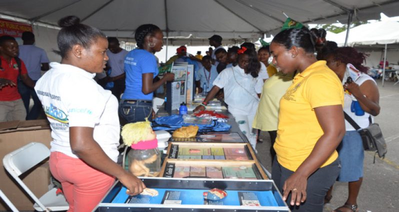 Students make good use of the services and facilities at the Mini Health Fair on the National Cultural Centre tarmac
