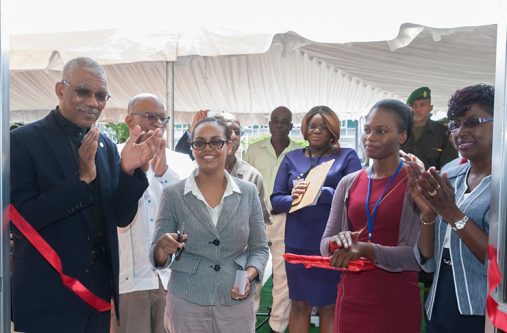 CAPTION: President David Granger and others applaud as a member of staff of the Bureau of Statistics cuts the ceremonial ribbon to open the new office at Main Street, Georgetown, on Friday (Photo by Delano Williams)