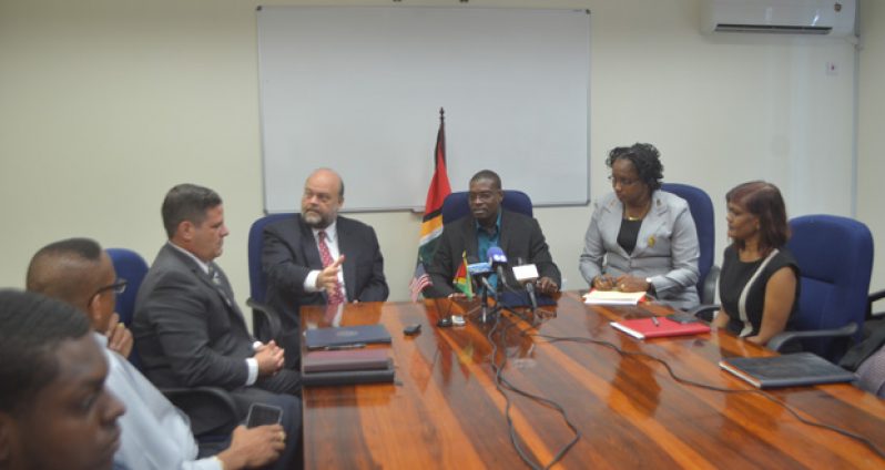 U.S. Ambassador Perry Holloway and Minister of Public Infrastructure David Patterson at the signing ceremony
