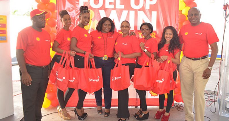 Shell V-Power Girls with SOL Sales Executive, Ms Renee Armstrong, centre, and Sol Country Manager, Mr Orlando Boxill, right