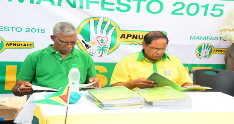 Presidential candidate, Brigadier (Rt’d) David Granger (left) and prime ministerial candidate, Moses Nagamootoo perusing the APNU+AFC manifesto yesterday