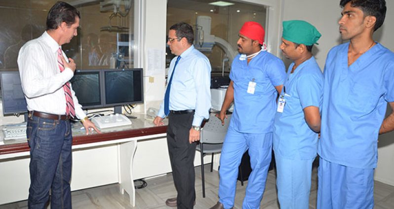 Drs. Rodriguez and Gomez (left and centre) along with other members of the cardiology team, demonstrates how the equipment in the Cath lab works.