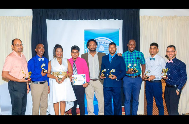 Guyana Chronicle winners from left: Rabindra Rooplall, Samuel Maughn,  Vanessa Braithwaite, Navendra Seoraj,  Board Director Ruel Johnson, Tajeram Mohabir, Rawl Toney, Ravin Singh (Overall winner of the GPA awards), and Stephan Sookram  (Delano Williams)