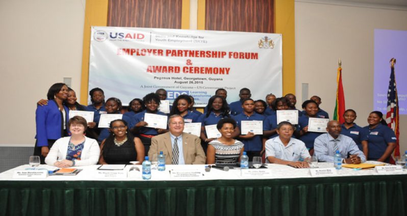 Graduates of the SKYE project pose with their certificates, while seated in front row are officials of SKYE Project and members of the private sector (Delano Williams photos)