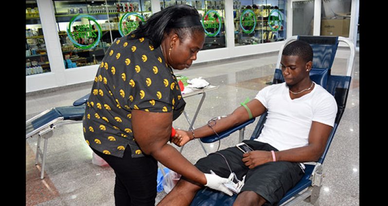 A Giftland Mall patron donating his pint yesterday during the company’s  blood drive (Photo by Samuel Maughn)