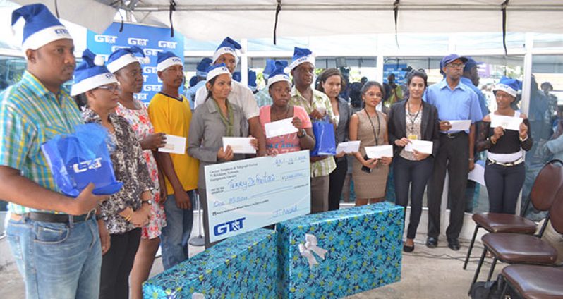 Media operatives (right), alongside $1M winner Terry DeFrietas and other winners, pose with their cheques and on-spot prizes