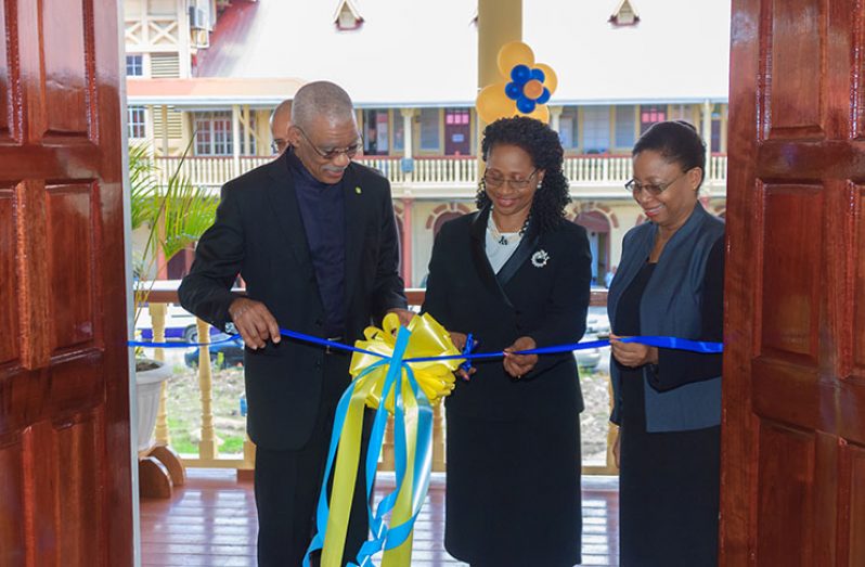 President David Granger is assisted by Chancellor of the Judiciary (ag), Yonette Cummings-Edwards and Chief Justice (ag), Roxanne George-Wiltshire, in cutting the ribbon to officially open the new wing of the High Court.