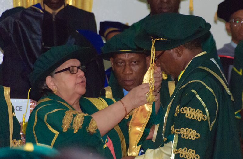 Vice-Chancellor Professor Ivelaw Griffith receives  ceremonial  garb from Pro-Chancellor of the University  of Guyana, Bibi Shadick