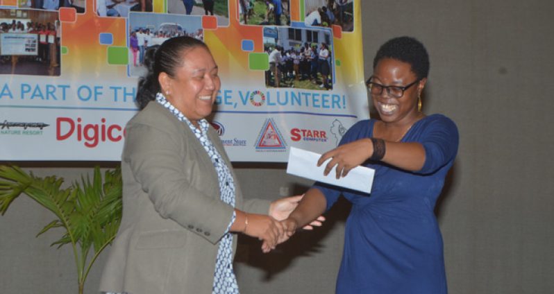 President Youth Awardee, Nikita Forde is excited about her trip to Jamaica, courtesy of Air Jamaica. She received her ticket from Grace Roberts during the awards ceremony yesterday