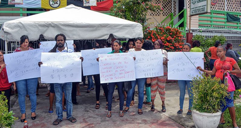 Parents with their placards protesting outside Mae’s yesterday morning