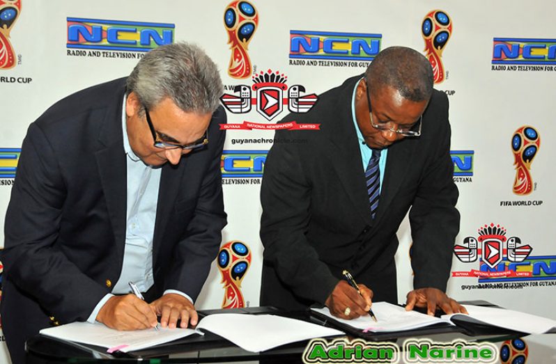 It’s a done deal! Bernard Pantin, DIRECTV’s Caribbean and Latin America Director (Left) and NCN’s CEO Lennox Cornette, signing there agreement to make NCN the Official Broadcast Rights Holder for the 2018 FIFA World Cup. (Adrian Narine photo)