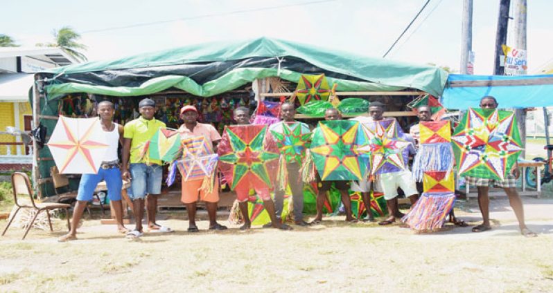 Marvin Cole with several youths at his kite tent displaying some of the kites they made for sale