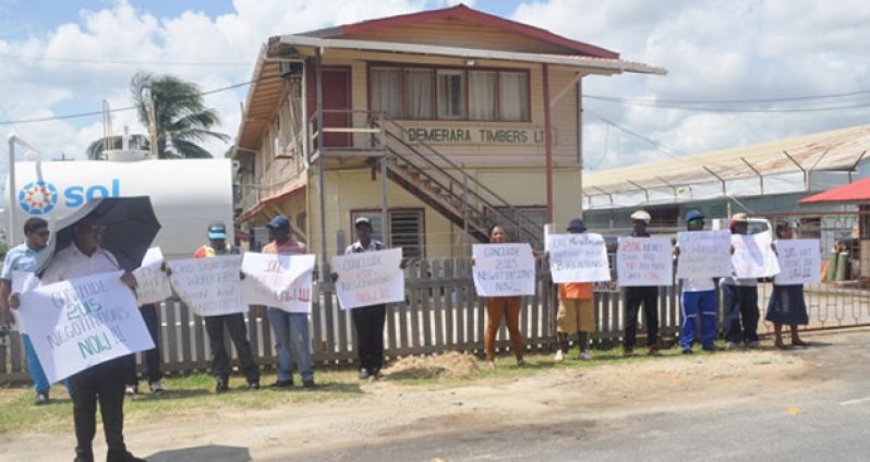 DTL workers and their union representatives picketing the DTL Head Office in Kingston, Georgetown