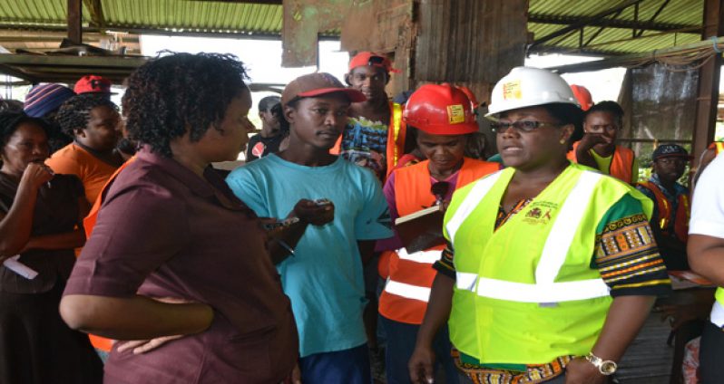 Minister Simona Broomes interacting with some of the aggrieved workers of DTL (file photo)