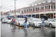 Taxi drivers sourcing passengers outside of Demico House, Stabroek (Delano Williams photos)