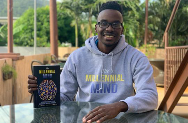 Daniel Francis with a copy of his book, ‘The Millennial Mind: Success Secrets for Unlocking Your Full Potential’