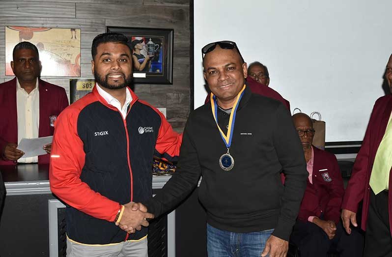 President of the Scarborough Cricket Association, Shiv Persaud (left), presents cricket umpire Daniel Singh with a medal at the recently held awards ceremony, hosted by the Canada Cricket Umpires Association (CCUA) at the Starlite Family Restaurant in Scarborough, Ontario, Canada