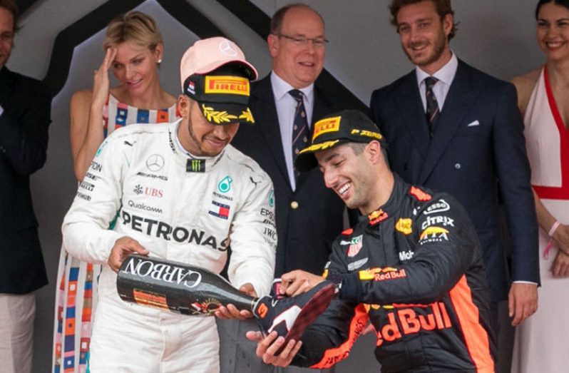 MONTE-CARLO, MONACO - MAY 27: Race winner Daniel Ricciardo of Australia and Red Bull Racing and Lewis Hamilton (L) celebrate on the podium during the Monaco Formula One Grand Prix at Circuit de Monaco on May 27, 2018 in Monte-Carlo, Monaco. (Photo by Marc Piasecki/WireImage)