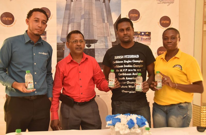 From left, Luis Ramirez-Merlano (Double Caribbean Champion), Sheik Yaseen, Sudesh Fitzgerald and Shondell Hyles pose with a bottle of Roosters Coconut Water at the conclusion of yesterday’s press conference. (Adrian Narine photo)