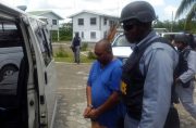 Barry Dataram being escorted by police after he arrived at Moleson Creek (Royston Drakes photo)