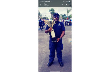 David Williams posing with one of his CPG trophies as a community-based leader