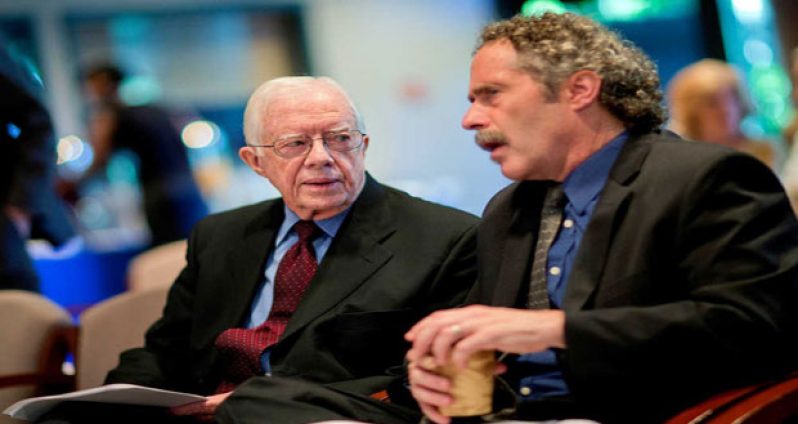 Former U.S. President Jimmy Carter, left, talks with Democracy Programme Director, David Carroll pictured at the Carter Centre in 2013 (Carter Center photo)