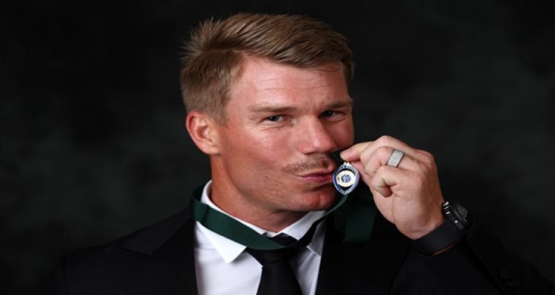 David Warner poses with the Allan Border Medal, Melbourne, yesterday.
