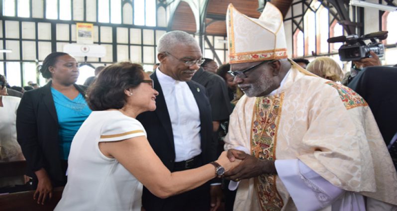 Bishop  Charles Alexander Davidson greets First Lady Sandra Granger in the presence of President David Granger.