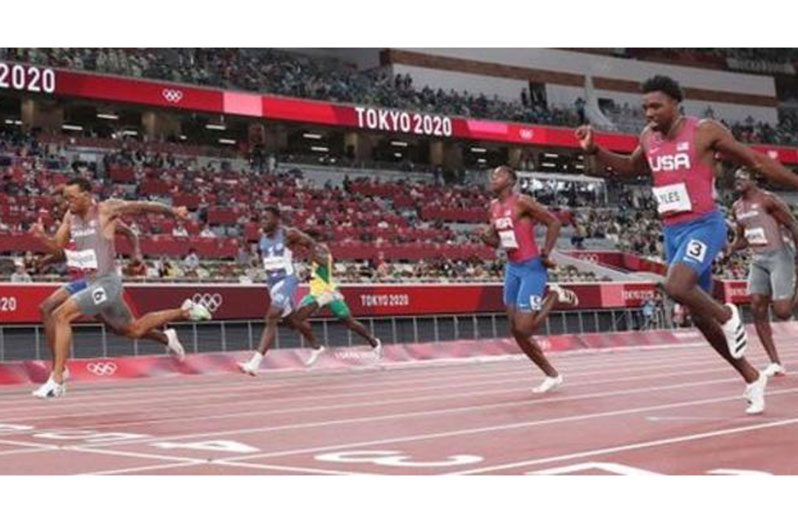 De Grasse (wearing six) and Bednarek (obscured) overhaul Lyles (three) in the final stage of the 200m final.