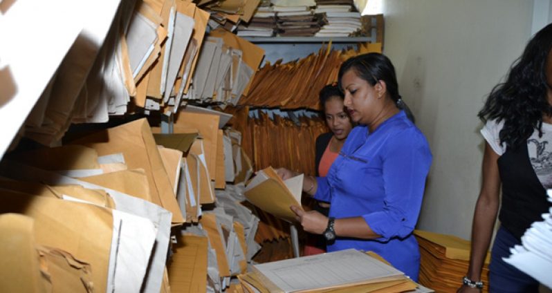 Workers inside the Deeds Registry, which still mostly uses a paper-based system