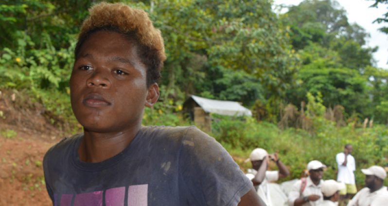 17-year-old Delwin Rogers stands in a shop at North Fork Backdam, Potaro, Region 8