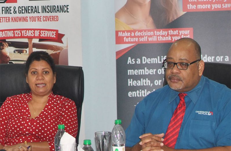 From Left to Right: Asha Ojha, Manager of Guyana Fire and General Insurance Company, and Clarence Perry, Executive Manager for Demerara Mutual Life Assurance Society Limited (Hughe Mclean photo)