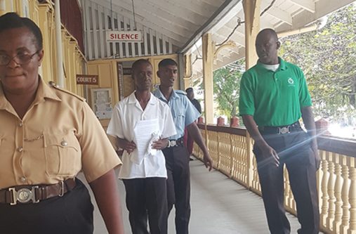 Deon Aaron being escorted to jail on Thursday (Photo by Michel Outridge)