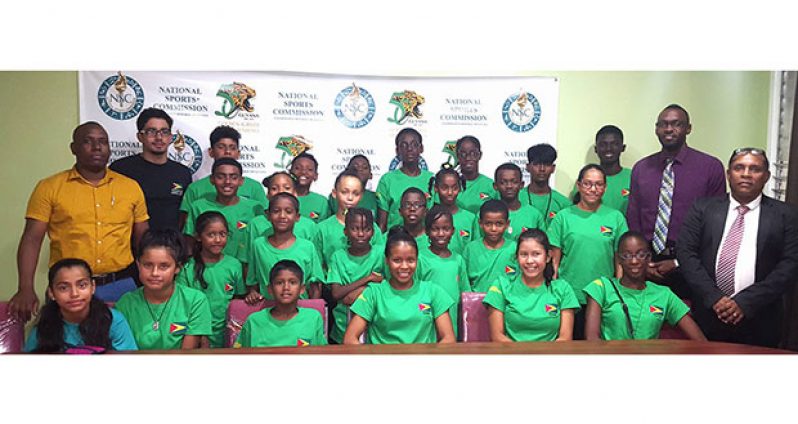 Director of Sport Christopher Jones (second from right) with the swimmers who will represent Guyana at this year’s Goodwill Swim Meet