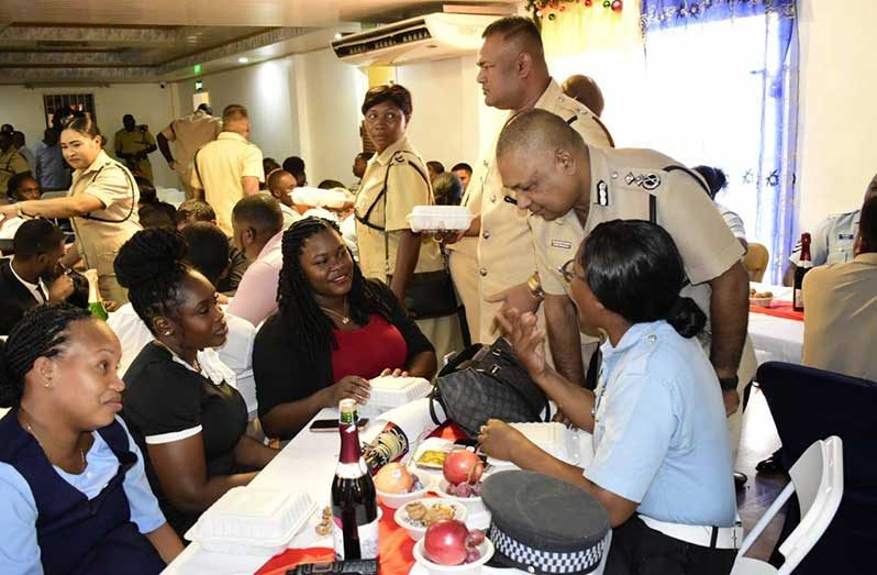Deputy Commissioner of Police (Administration) Ravindradat Budhram listens keenly to one of the many ranks whom he spoke to at the Region Three police awards ceremony