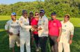Derek Kalicharran (left), accepts the tokens from Raj Rai in the presence of other club members