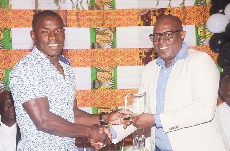 Desmond Amsterdam (left) receives his award from GBA head, Steve Ninvalle.